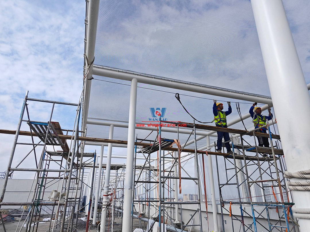 Focusing on high-quality construction, this mesh fabric curtain wall is under construction and installation