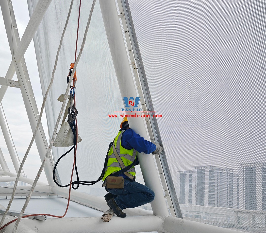 Focusing on high-quality construction, this mesh fabric curtain wall is under construction and installation