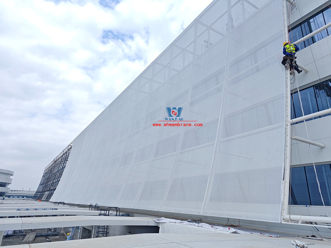 Focusing on high-quality construction, this mesh fabric curtain wall is under construction and installation