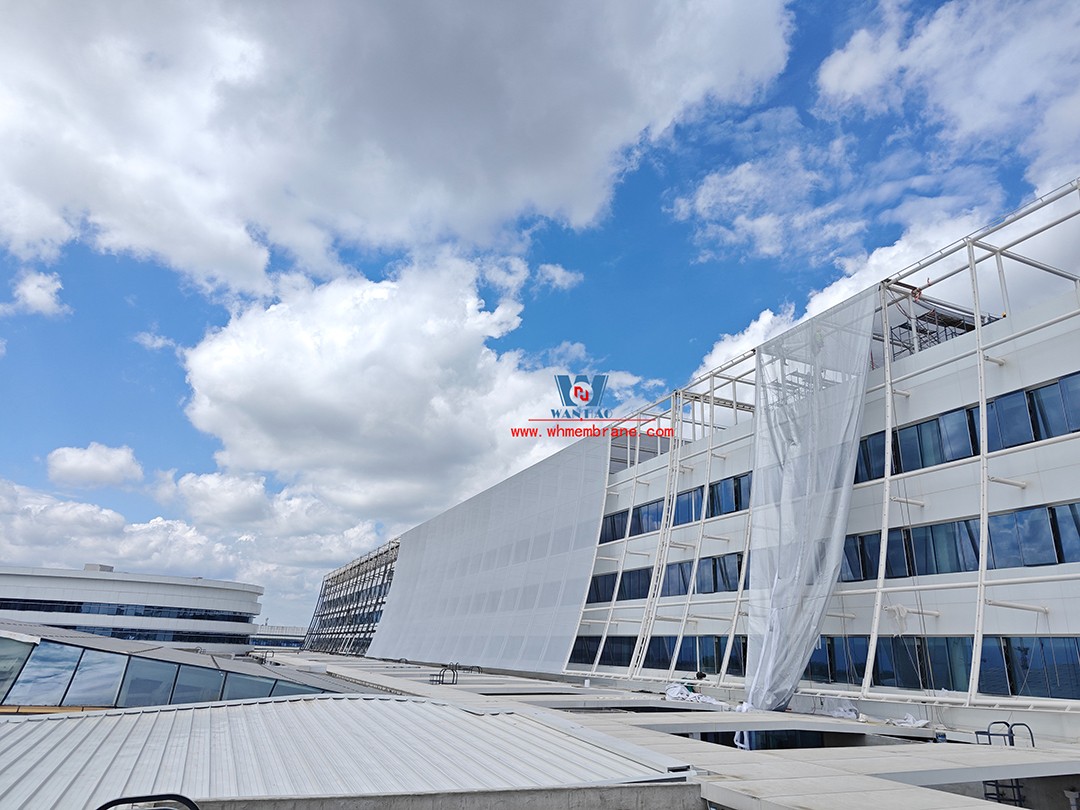 Focusing on high-quality construction, this mesh fabric curtain wall is under construction and installation