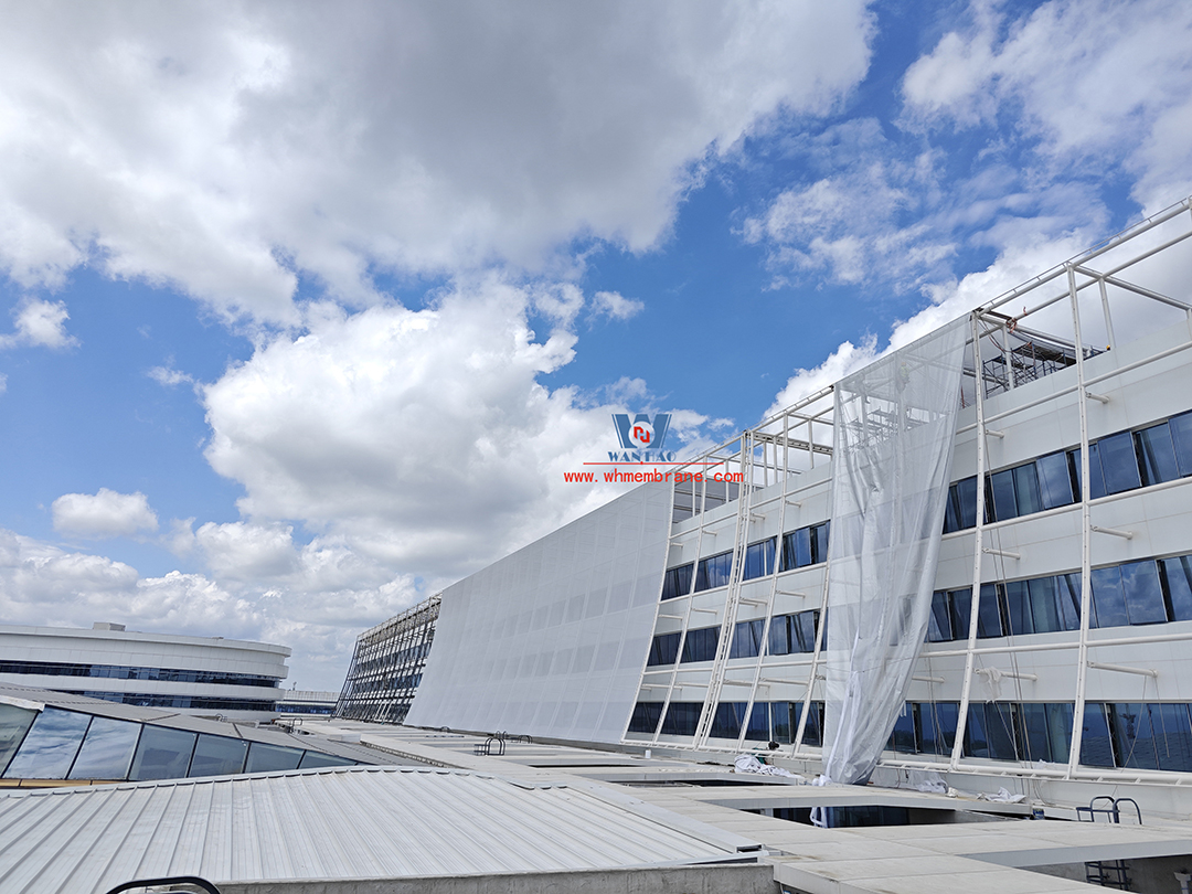 Focusing on high-quality construction, this mesh fabric curtain wall is under construction and installation